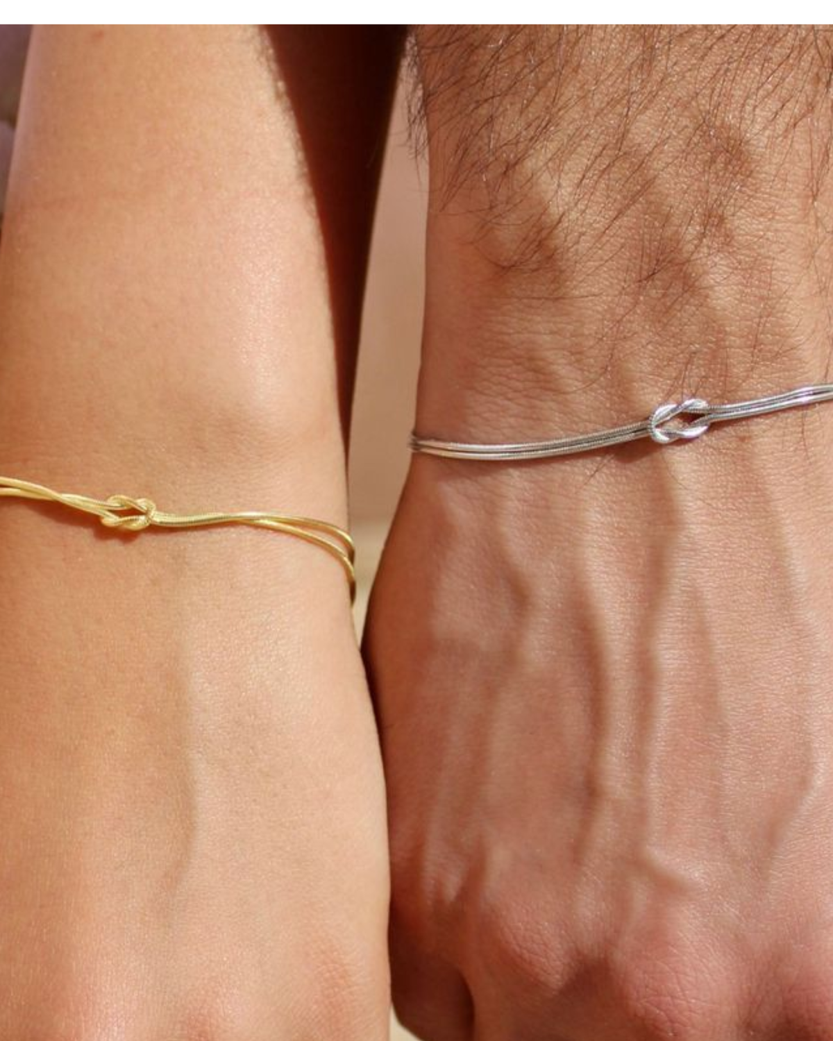 Matching knot bracelets on a couple's wrists side by side