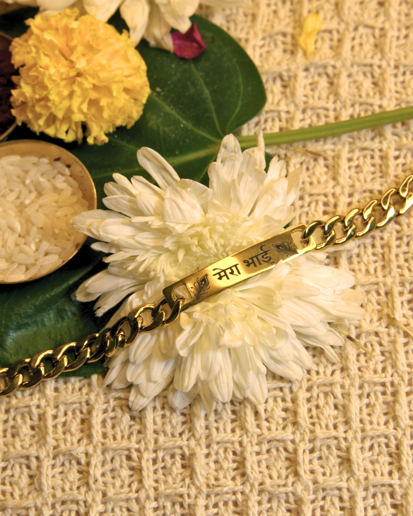 Engraved rakhi bracelet with rice, roli and flowers