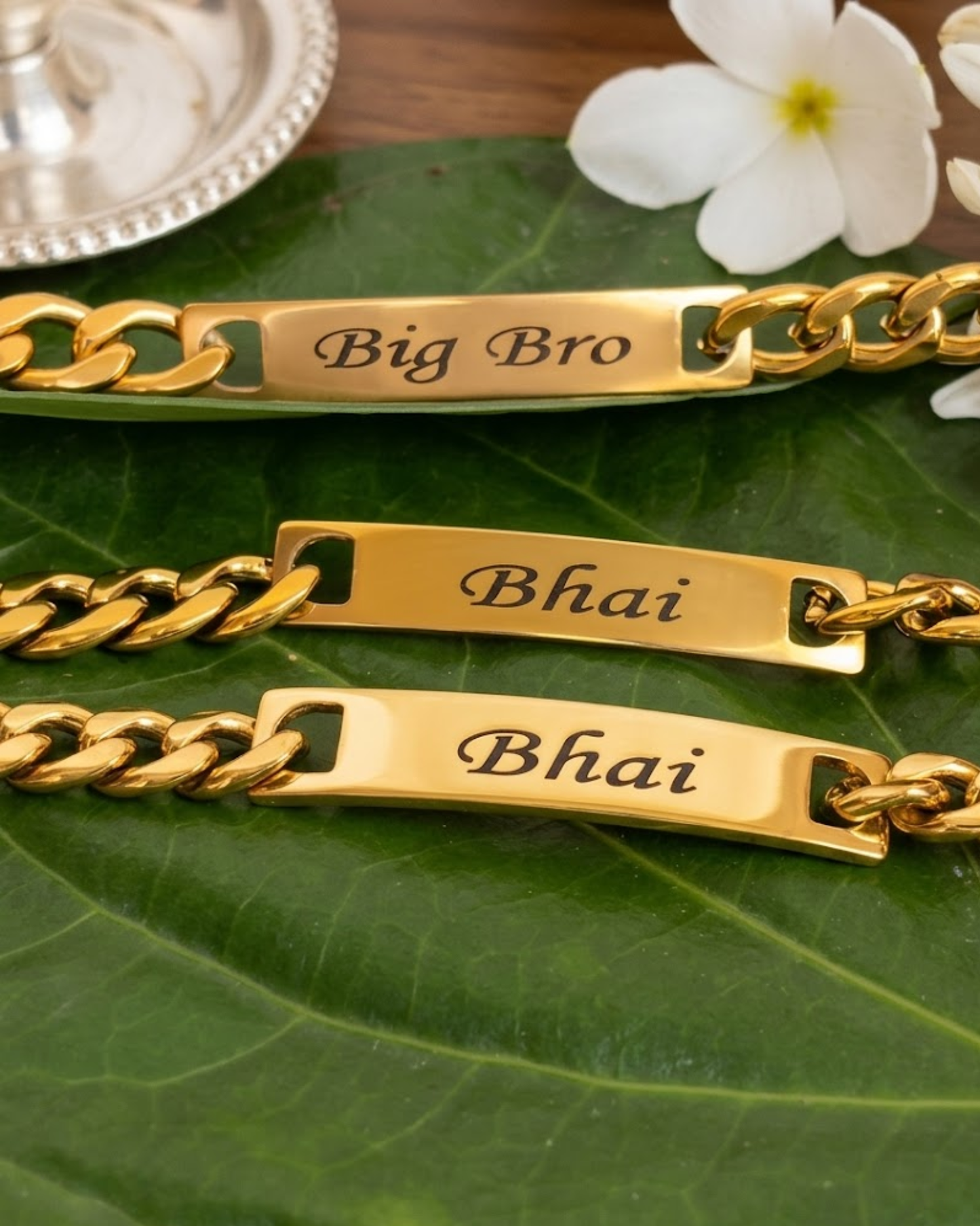 Big Bro and Bhai engraved bracelets on a leaf